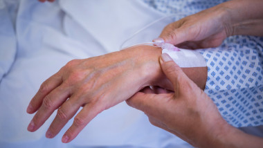 Nurse attaching iv drip on patient s hand in hospital