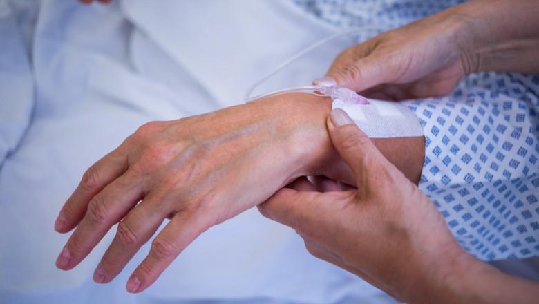 Nurse attaching iv drip on patient s hand in hospital