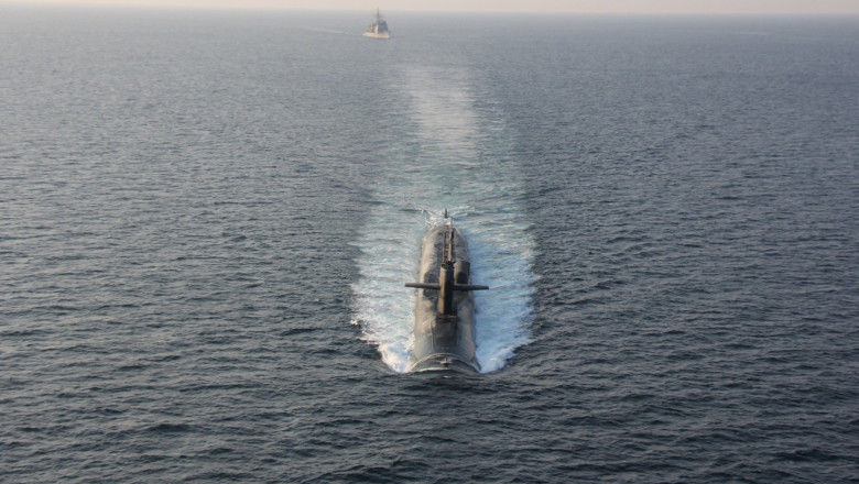 The guided-missile submarine USS Georgia transits the Strait of Hormuz