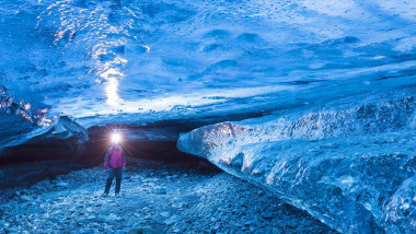 Tourist visiting The Crystal, natural ice cave in the Breiðamerkurjökull, Iceland