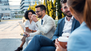 Group,Of,Coworkers,Having,A,Coffee,Brake,Together,,Siting,Outside