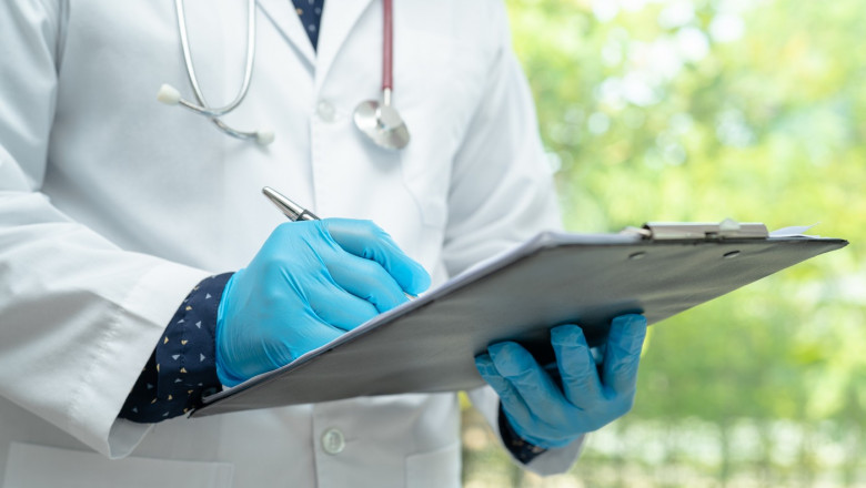 Doctor checking and note diagnosis medicine in clipboard of pati