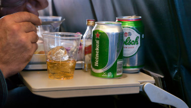 Alcohol being consumed by someone on a plane