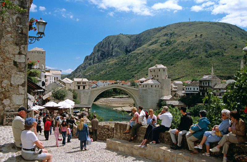 Stari Most, Old Bridge, following reconstruction, tourists and Neretva River, Mostar, Bosnia Herzegovina, Former Yugoslavia