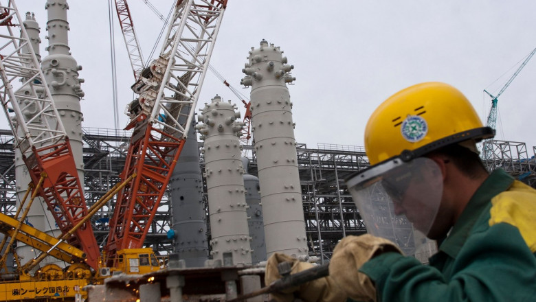 Workmen at work at the Sakenergy liquefied natural gas plant and oil export terminal at Prigorodnye, Sakhalin, Russia