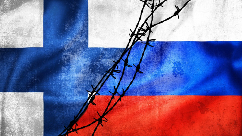 Grunge flags of Russian Federation and Finland divided by barb wire illustration