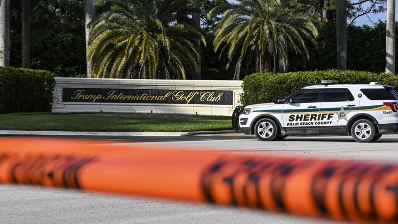 A Sherrif block the street outside the Trump International Golf Club in West Palm Beach, Florida