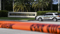 A Sherrif block the street outside the Trump International Golf Club in West Palm Beach, Florida