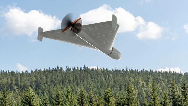 View from below of a Russian army combat drone Shahid against a forest background , flying over the ground of the war in Ukraine, drone attack.