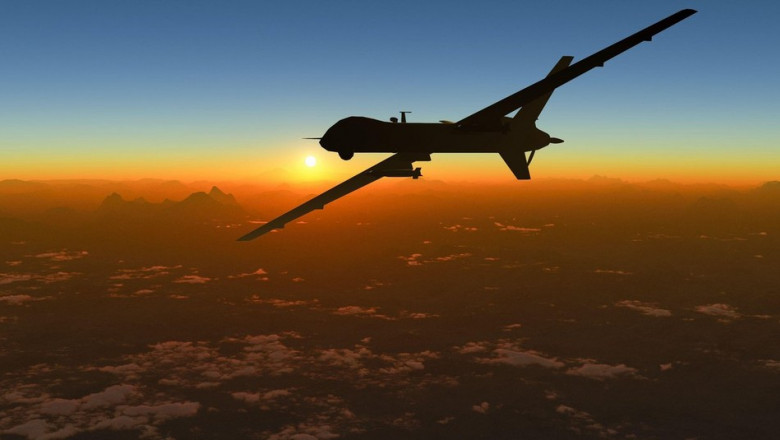 Aerial view and silhouette of a military drone flying over a mountain range at sunset. Military mission and target. 3d rendering