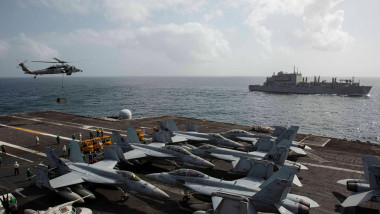 240916-N-AB116-6083 U.S. CENTRAL COMMAND AREA OF RESPONSIBILITY (Sept. 16, 2024) An MH-60S Sea Hawk helicopter, attached to Helicopter Sea Combat Squadron (HSC) 14, delivers cargo to the flight deck of the Nimitz-class aircraft carrier USS Abraham Lincoln