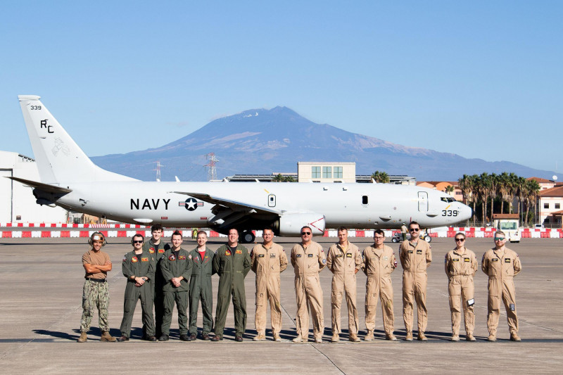 231117-N-AN659-2015 NAVAL AIR STATION SIGONELLA, Italy (Nov. 17, 2023) U.S. Navy Sailors attached to Patrol Squadron (VP) 46, the Grey Knights, and Sailors of the 30th Air Squadron of the Polish Navy stand in front of a P-8A Poseidon on the flightline