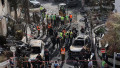 Residents watch as first responders and Israeli security forces gather amid debris and charred vehicles in Kiryat Bialik in the Haifa district of Israel, following a reported strike by Lebanon's Hezbollah on September 22, 2024