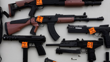 Image of a wide range of guns for sale at a country fete in france