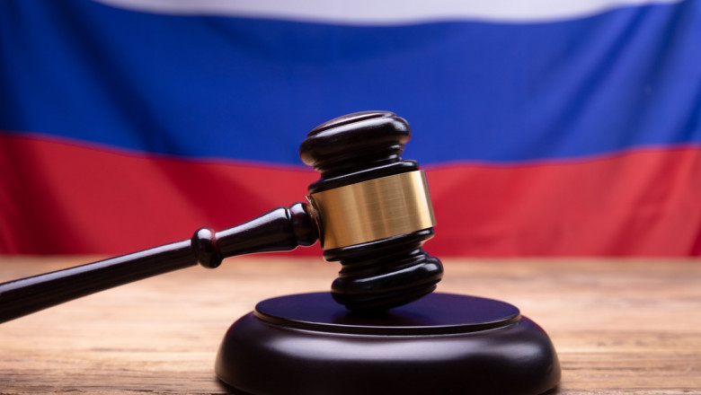 Close-up Of Judge Gavel In Front Of Russian Flag