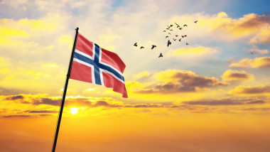 Waving,Flag,Of,Norway,Against,The,Background,Of,A,Sunset