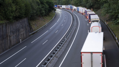 stack of trucks in a long traffic jam on the freeway