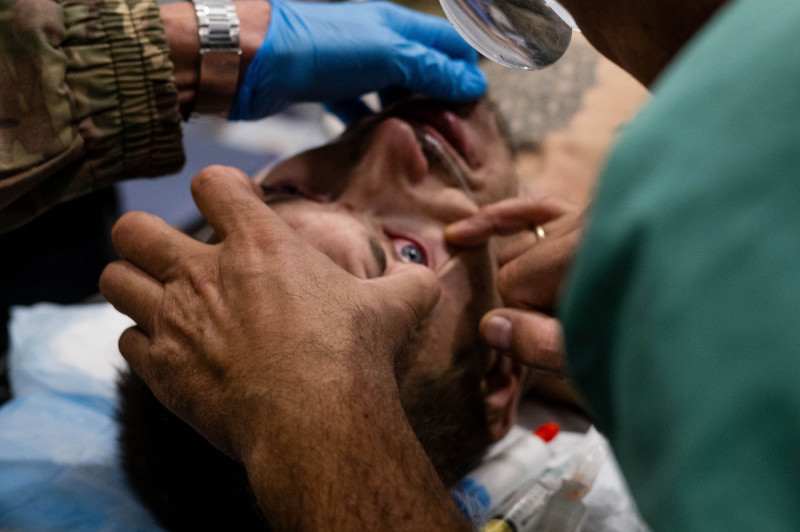 Ukrainian army medics treat wounded soldiers at a stabilization point in Donetsk Oblast