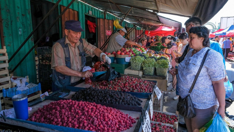 Karaganda, Kazakhstan - August 18, 2023: A strawberry and blackberry vendor at the New Bazaar in Karaganda, Kazakhstan.