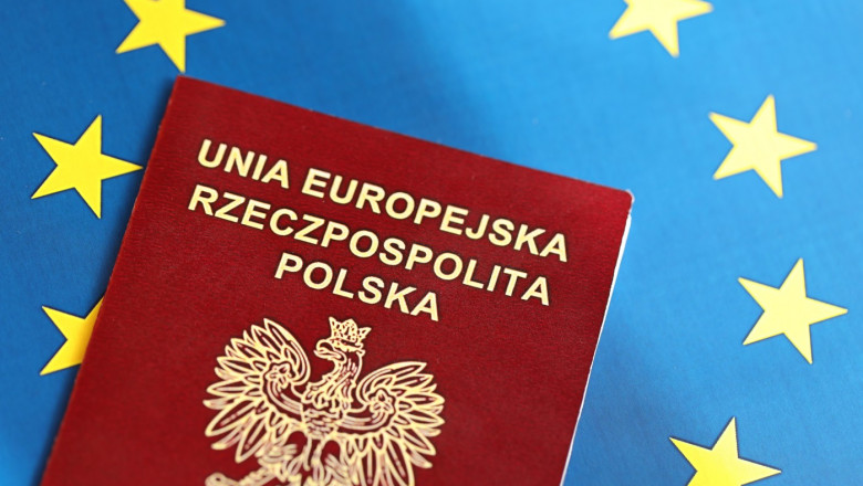 Poland passport of European Union on blue flag background close up. Tourism and citizenship