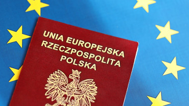 Poland passport of European Union on blue flag background close up. Tourism and citizenship