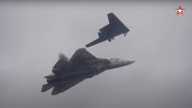 S-70 Okhotnik drone pictured along Su-57 fighter jet during a flight.