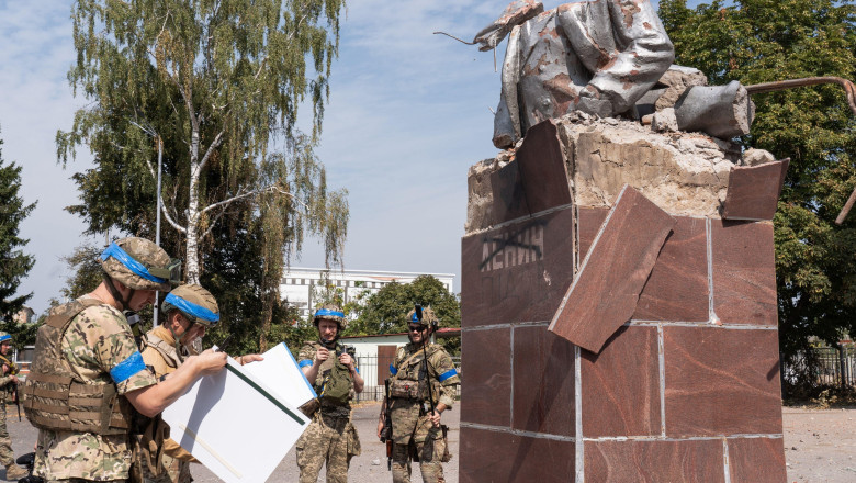Ukrainian soldiers try to stick a photo of war in Ukraine below a completely demolished monument of Vladimir Lenin in the centre square in Sudzha. Ukraine conducts an incursion in Russias Kursk region and have seized territory, including occupying Sudzha