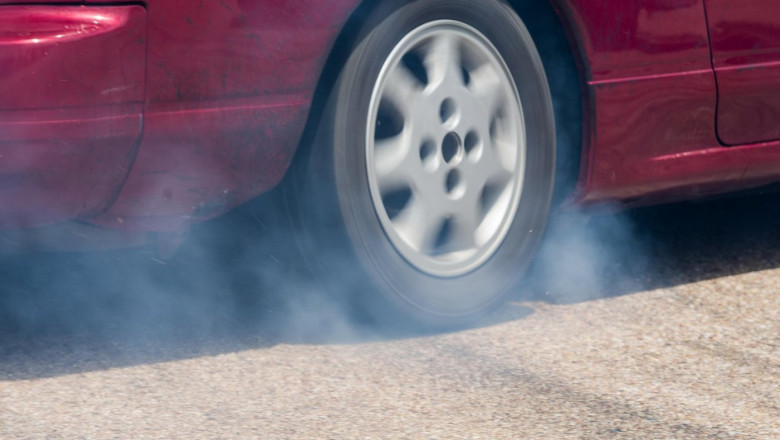 Rear wheel drive car burning tire for warm up