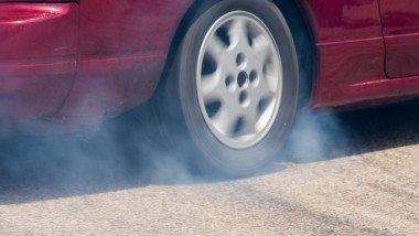 Rear wheel drive car burning tire for warm up