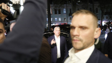 Hungarian Prime Minister Victor Orban cheks into his hotel in tbilisi, guarded by staff members