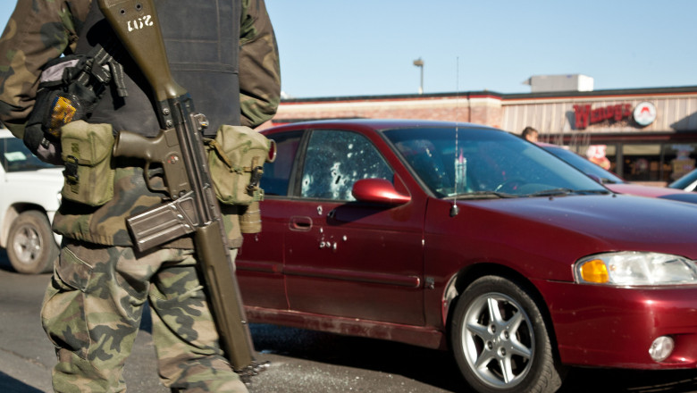 Mexican soldiers guard a crime scene where assigns shot dead a policeman in the drug wars Juarez, Mexico