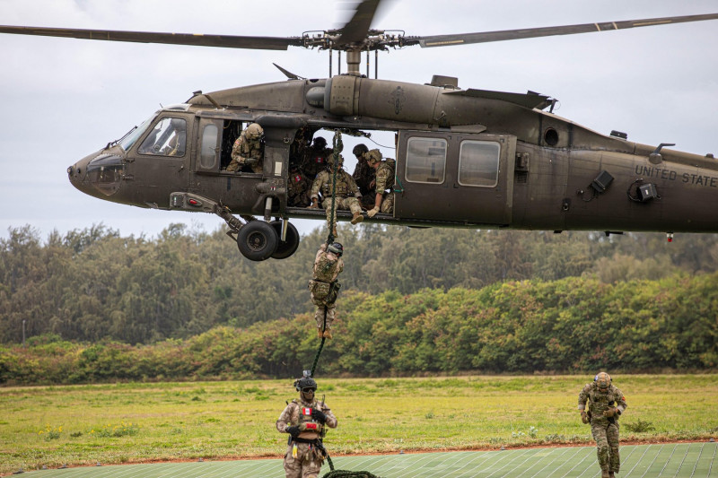 U.S. Army Soldiers from 2nd Battalion, 25th Aviation Regiment, 25th Combat Aviation Brigade, 25th Infantry Division, provide air support on a UH-60 Black Hawk with multiple Fast Rope Insertion and Extraction System (FRIES) iterations for U.S. Naval Specia