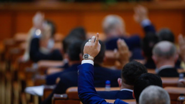 Bucharest, Romania - December 22, 2020: Romanian deputies vote bills by raising their hands in a full Chamber of Deputies meeting.