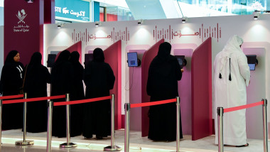 Qatari voters cast their electronic votes at a polling station in Doha,