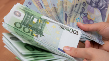 Girl hands counting Romanian LEI currency and Euro banknotes, close up