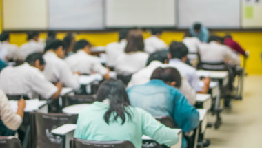 Blur,Abstract,Background,Of,Examination,Room,With,Undergraduate,Students,Inside.