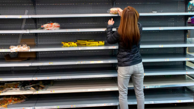 Woman,Shopping,Among,Empty,Shelves,At,A,Supermarket,During,Coronavirus