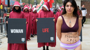 London, UK. 8th November, 2024. Protesters dressed in Handmaid's Tale costumes led by a woman representing student Ahoo Daryaei marched in solidarity with the 30-year old who was stopped by morality police for being 'improperly dressed at Tehran's Islamic