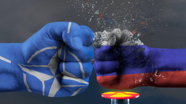 Confrontation NATO and Russia. Military conflict in Ukraine. The threat of nuclear war. NATO fist breaks a fist painted in the colors of the Russian