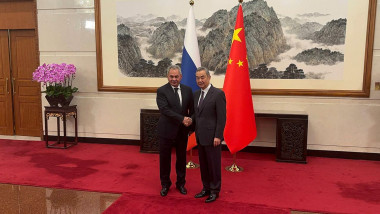 secretary of Russia's Security Council Sergei Shoigu meets with Chinese Foreign Minister Wang Yi in Beijing, shake hands