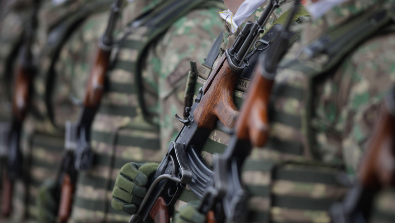 Bucharest, Romania - January 24, 2024: Details with a Romanian army soldier holding an AK 47 assault rifle during a military ceremony at the Monument