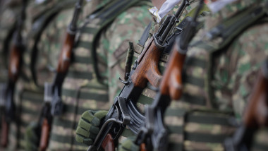 Bucharest, Romania - January 24, 2024: Details with a Romanian army soldier holding an AK 47 assault rifle during a military ceremony at the Monument