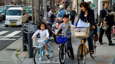 Ginza Tokyo smartest shopping area bike bicycle cycle mother with child children boy girl traffic