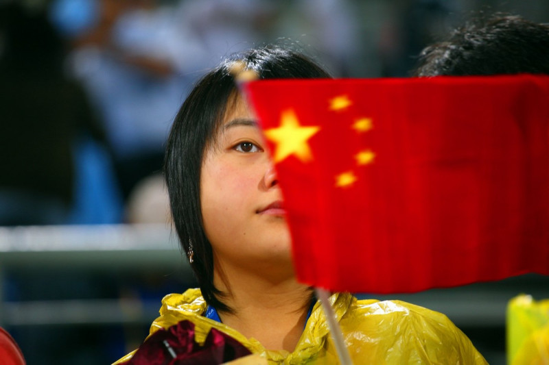 Chinese female waving national flag at Ladies Hockey Finals, Beijing Olympics, China