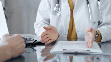 Doctor,And,Patient,Consultation,With,Clipboard,And,Medication,Notes.,Close-up