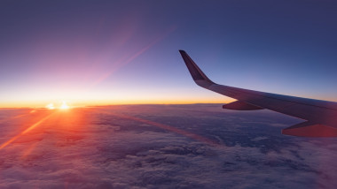 Airplane,Flying,Low,Over,Snowy,Mountains,And,Preparing,For,Landing