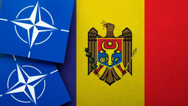 LONDON, UK - August 2022: NATO North Atlantic Treaty Organization military alliance logo on a Moldova flag