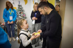 Zaporizhzhia, Ukraine. 12th Dec, 2024. Ukrainian President Volodymyr Zelenskyy, right, speaks with a young girl during a visit to the first school built underground, December 12, 2024 in Zaporizhzhia, Zaporizhzhia Oblast, Ukraine. The school, built to pro