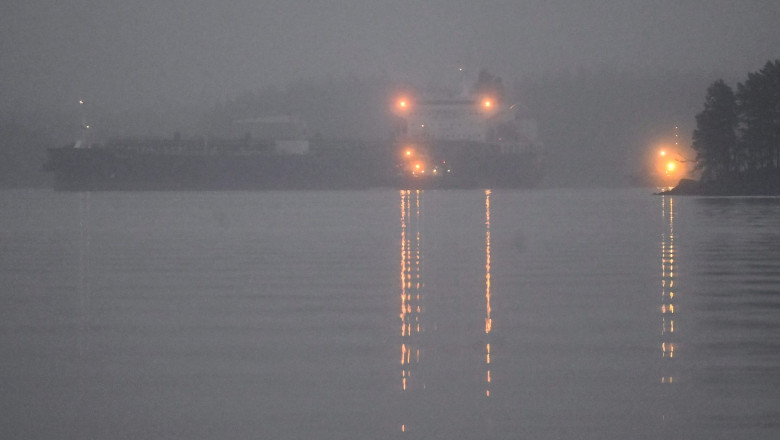 Oil tanker Eagle S is escorted by a tugboat