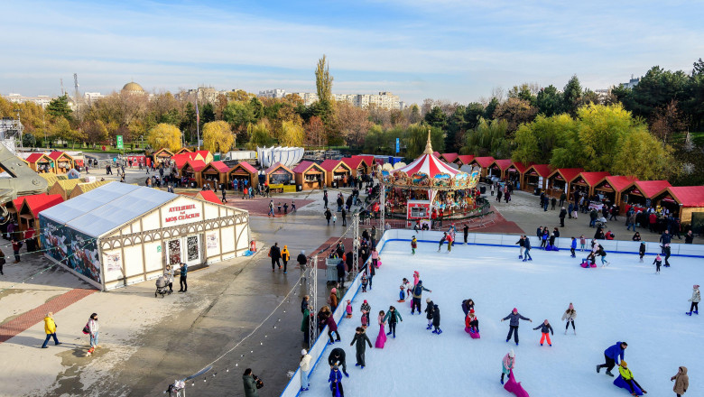 Bucharest, Romania, 30 November 2023: Vivid colorful houses and ice skate ring at West Side Christmas Market in Drumul Taberei neignbourhood, in a sun